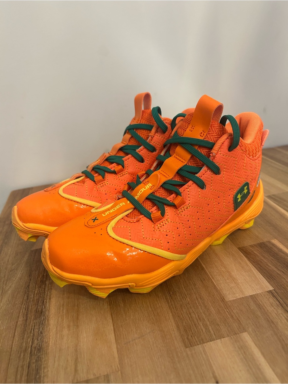Under Armour Bright Orange Kids' Cleats with Green Laces